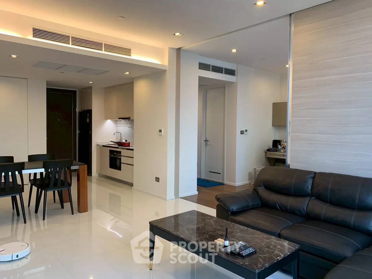 Modern open-plan living room with sleek kitchen and stylish furniture