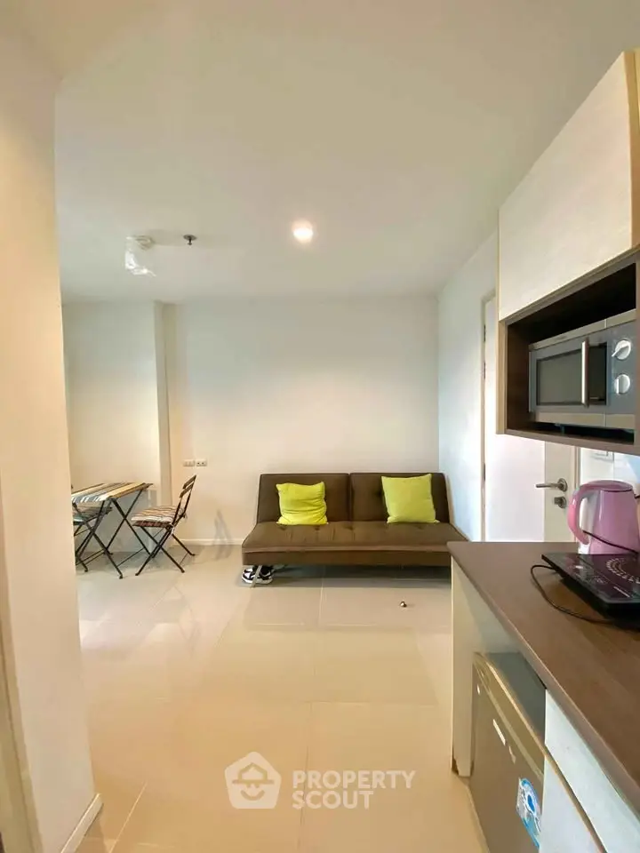 Modern apartment interior with cozy living area and compact kitchen