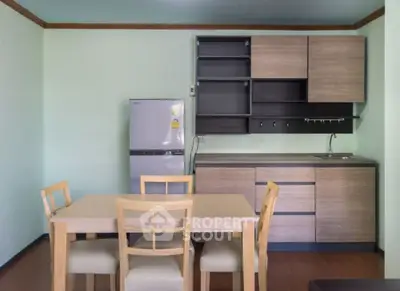 Modern kitchen with wooden cabinets and dining table in cozy apartment