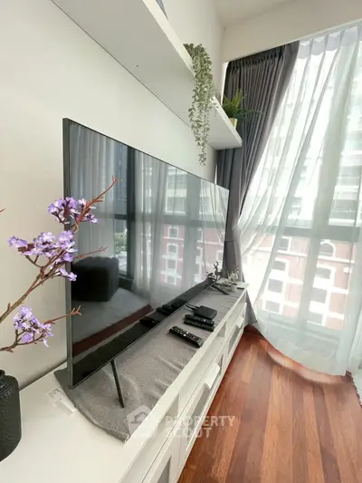 Modern living room with sleek TV setup and large window view