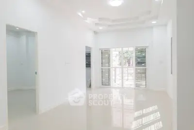 Spacious modern living room with large windows and glossy floors