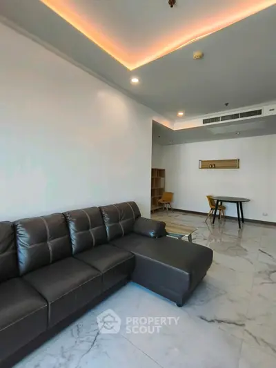 Modern living room with leather sofa and marble flooring