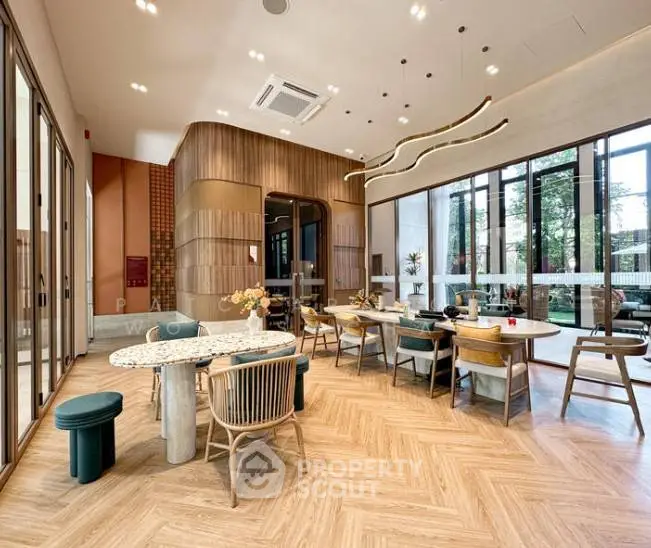 Modern and spacious living area with elegant furniture and large windows