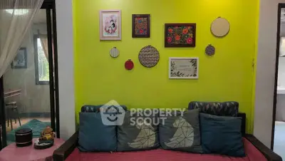Charming living room with vibrant wall art and cozy seating area