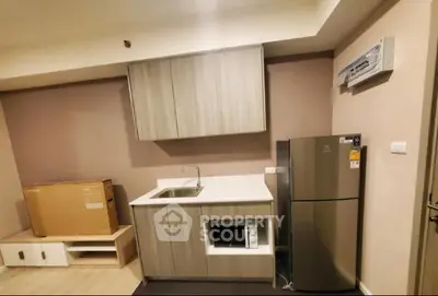 Modern kitchen with sleek cabinetry and stainless steel appliances in a compact layout.