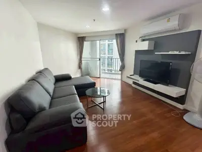 Modern living room with sleek furniture and balcony view