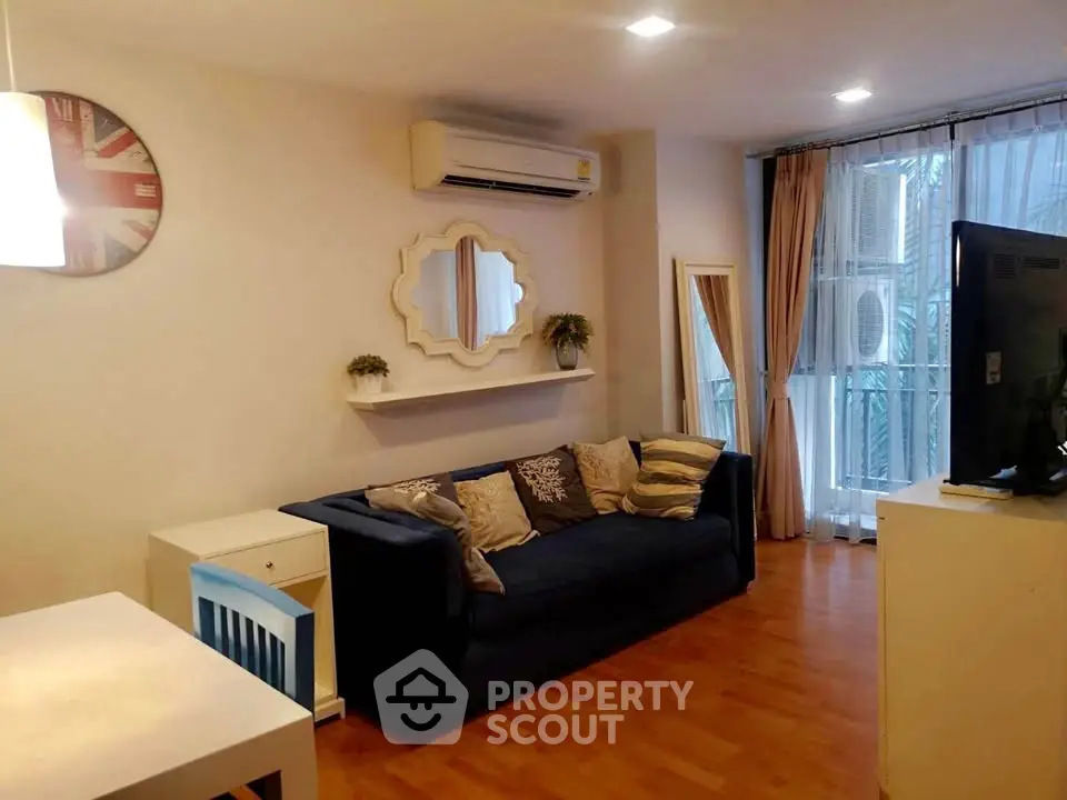 Charming living room with modern decor and natural light, featuring a cozy sofa and stylish wall mirror.