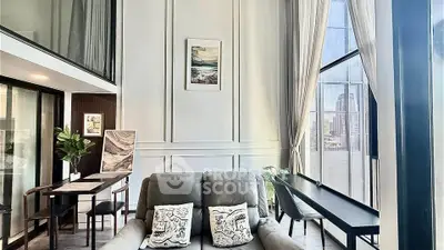 Luxurious living room with high ceilings and city view, featuring elegant decor and abundant natural light.