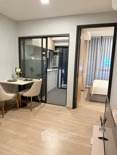 Modern apartment interior with cozy dining area and view into bedroom