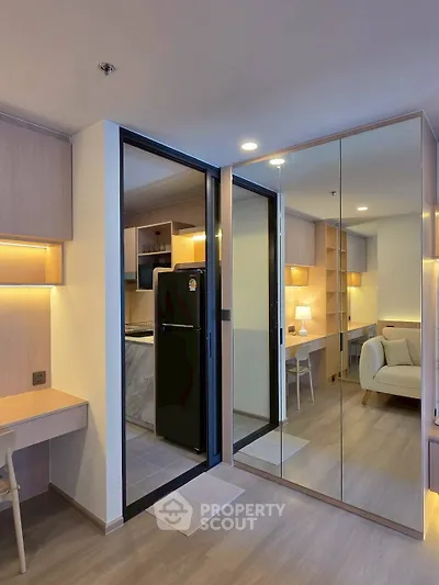 Modern apartment interior with mirrored closet and cozy living area