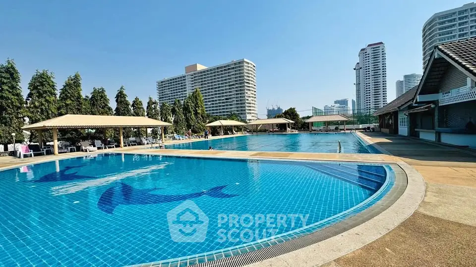 Luxurious outdoor pool area with city skyline views, perfect for relaxation and leisure in a prime real estate location.