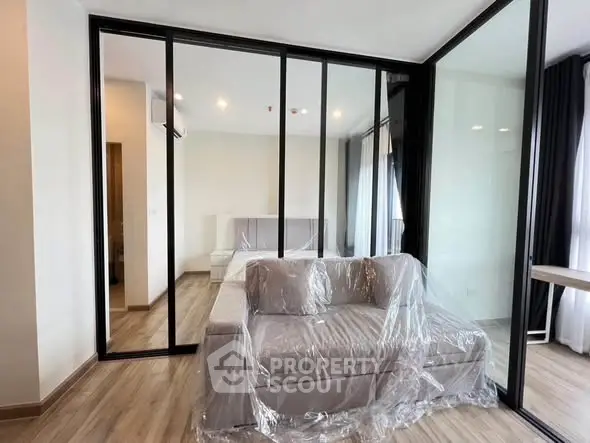 Modern apartment with glass partition and cozy sofa in living area
