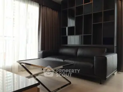 Modern living room with sleek black leather sofa and stylish coffee table