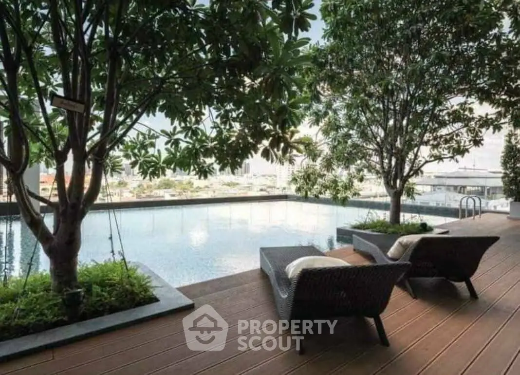 Luxurious rooftop pool with stunning city views and lush greenery, perfect for relaxation.