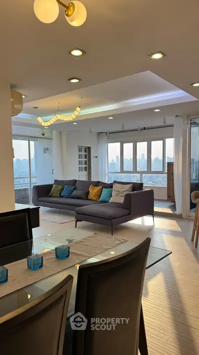 Spacious living room with panoramic city views and modern decor