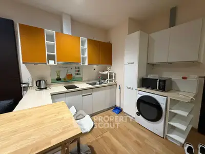 Modern kitchen with sleek cabinets, wooden flooring, and built-in appliances for a stylish home.