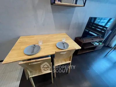 Modern living room with stylish dining setup and sleek TV unit