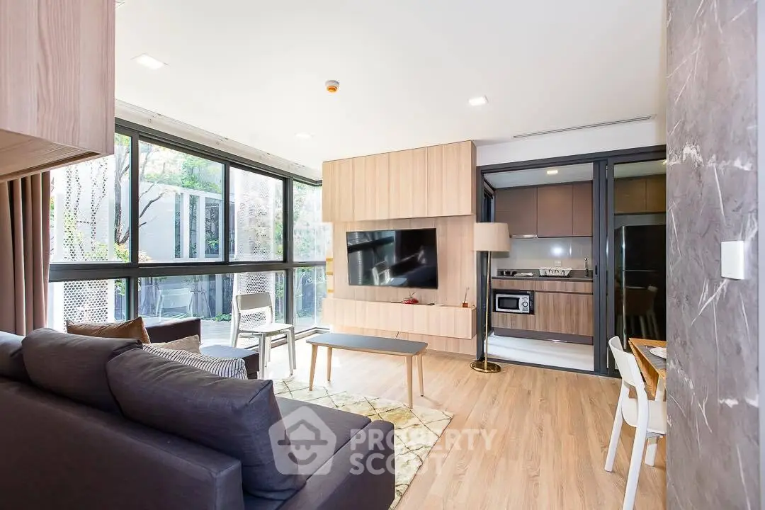 Modern living room with large windows and stylish decor in a contemporary apartment.
