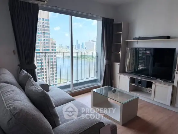 Modern living room with city view and balcony access in high-rise apartment.