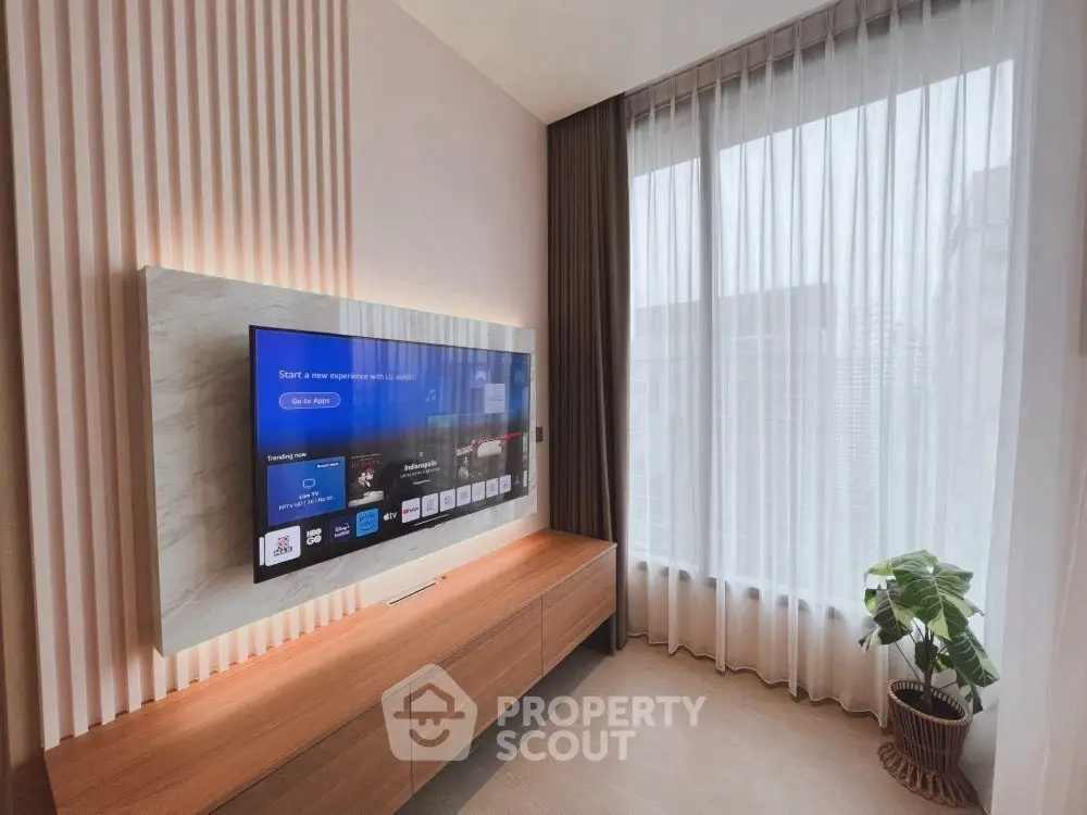 Modern living room with sleek TV setup and large window view