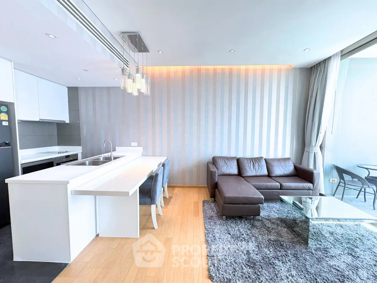 Modern open-layout living room with sleek kitchen and stylish decor