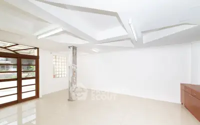 Spacious modern room with unique ceiling design and natural light