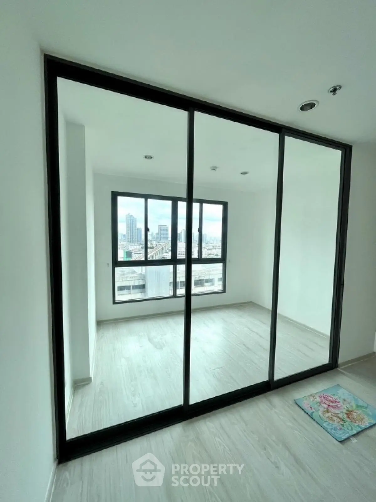 Spacious modern apartment with large windows and city view