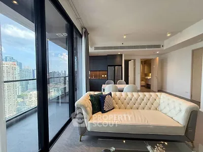 Luxurious living room with stunning city view and modern open kitchen layout.