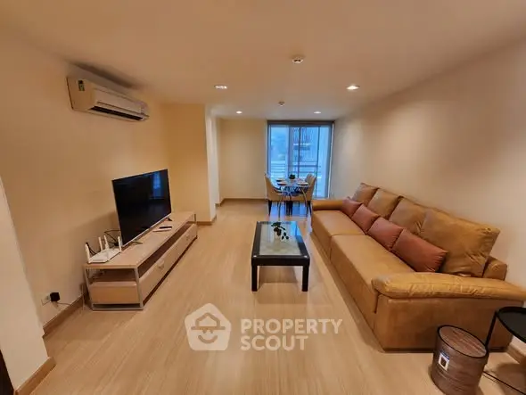 Spacious living room with modern decor and large sofa, perfect for relaxation.