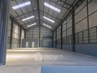 Spacious industrial warehouse with high ceilings and ample storage space.