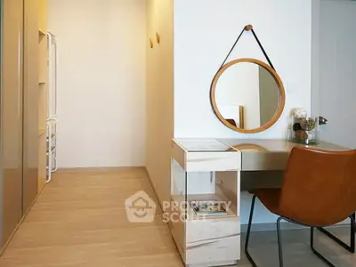Modern study area with stylish desk, chair, and round mirror in a bright apartment.