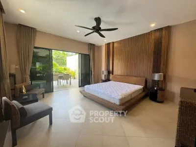 Luxurious bedroom with modern decor and large sliding doors to a private patio, offering a serene and stylish retreat.