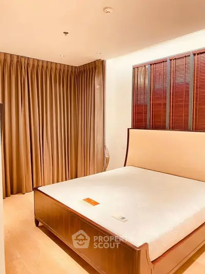 Spacious bedroom with elegant wooden bed and warm lighting
