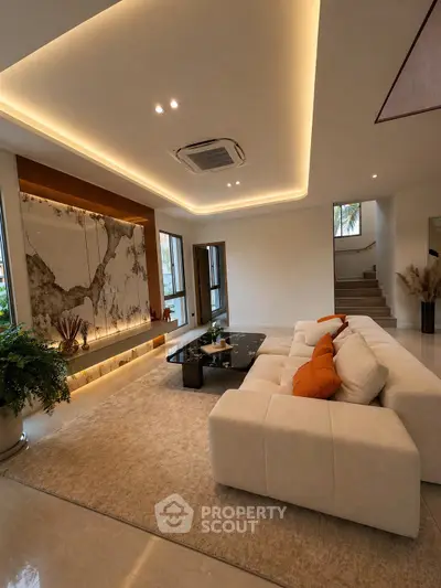Luxurious modern living room with elegant lighting and plush seating, perfect for relaxation and entertainment.
