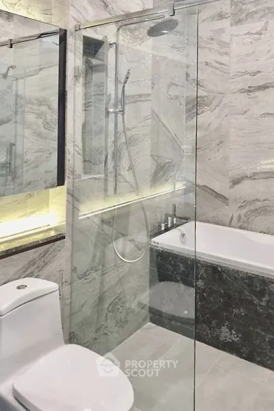 Luxurious modern bathroom with glass shower and elegant marble finishes