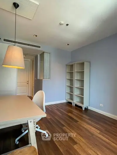 Spacious study room with wooden flooring and modern furniture