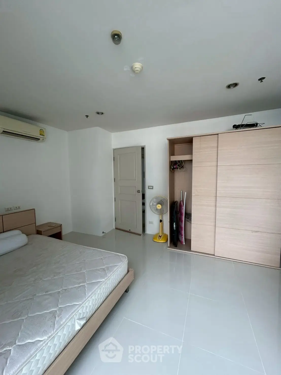 Spacious bedroom with modern wardrobe and air conditioning
