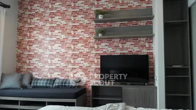 Modern living room with brick accent wall and sleek TV setup