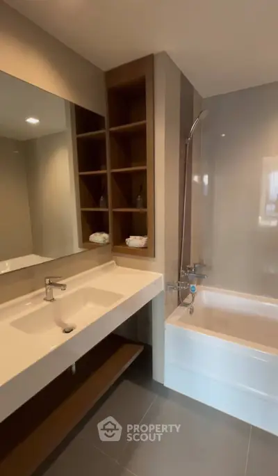 Modern bathroom with sleek design and bathtub in a contemporary apartment.