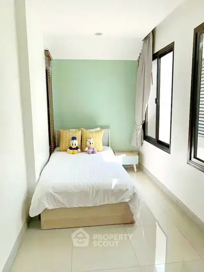 Bright and cozy bedroom with large windows and modern decor