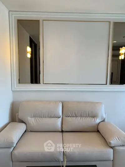 Modern living room with elegant white sofa and stylish wall decor