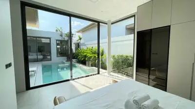 Luxurious bedroom with pool view and modern design in a contemporary home