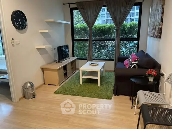 Cozy living room with modern decor and garden view, perfect for relaxation.