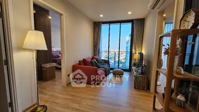 Modern living room with city view, cozy red sofa, and stylish decor