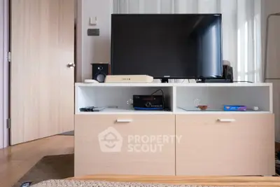 Modern living room with sleek TV stand and flat-screen TV, perfect for entertainment.