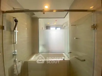 Modern bathroom with glass shower and bathtub in luxury apartment