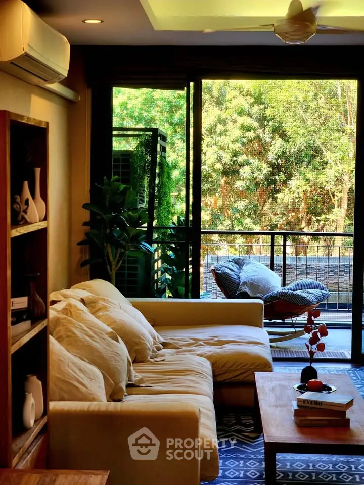 Charming living room with cozy sofa and balcony view, perfect for relaxation.