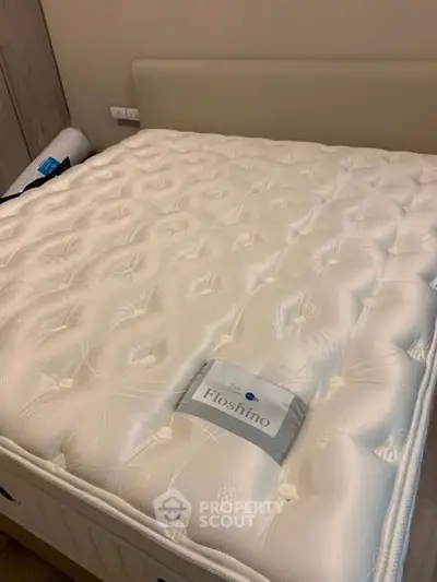 Luxurious bedroom with plush mattress and elegant headboard, perfect for restful nights.