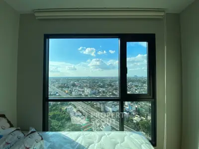 Stunning cityscape view from a modern bedroom window, showcasing urban living at its finest.