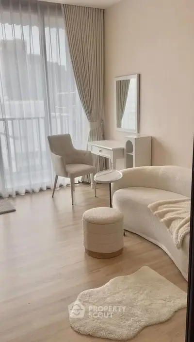 Elegant living room with modern furniture and large windows for natural light.